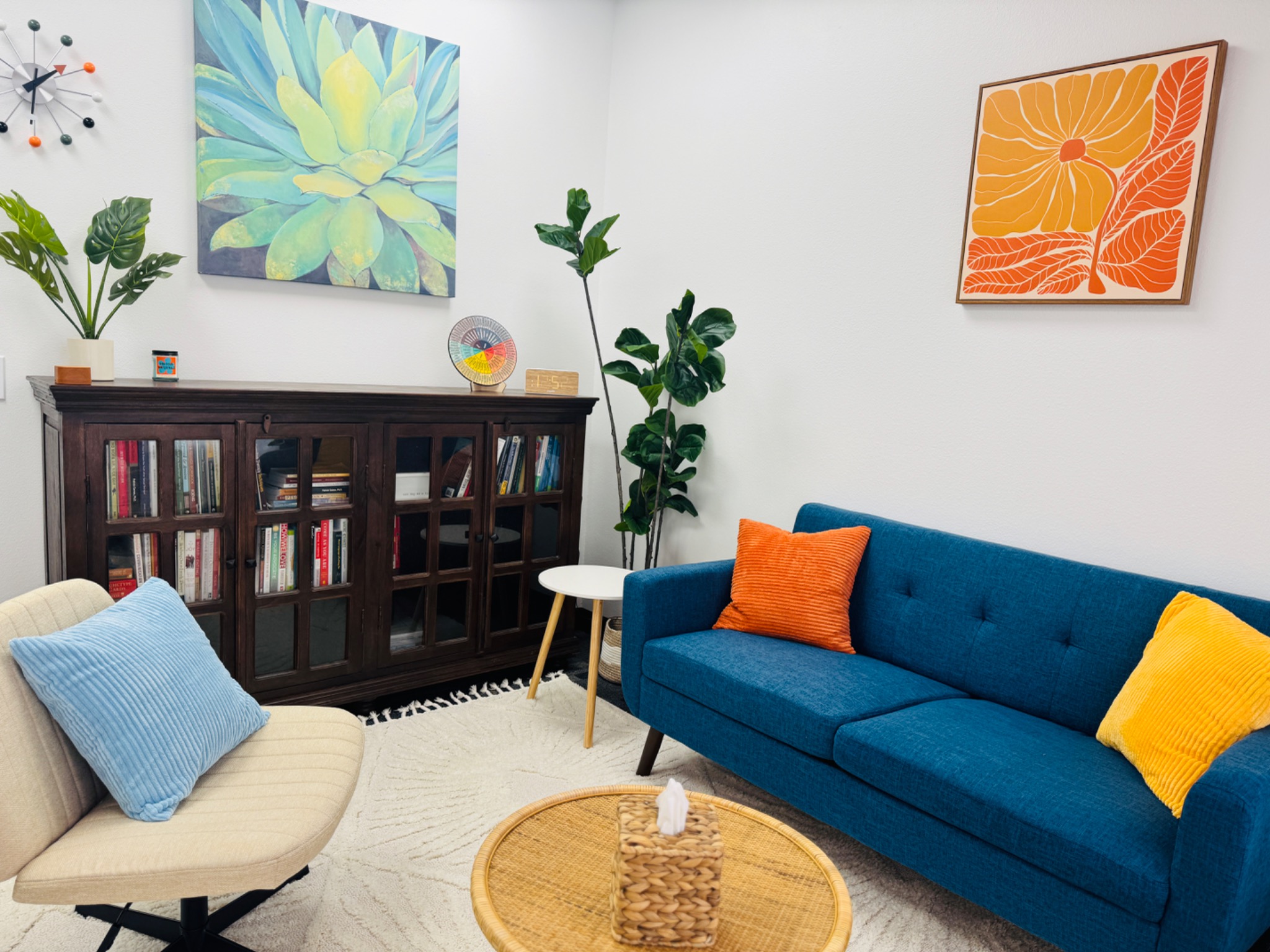 Comfortable counseling office with blue sofa and bookcase